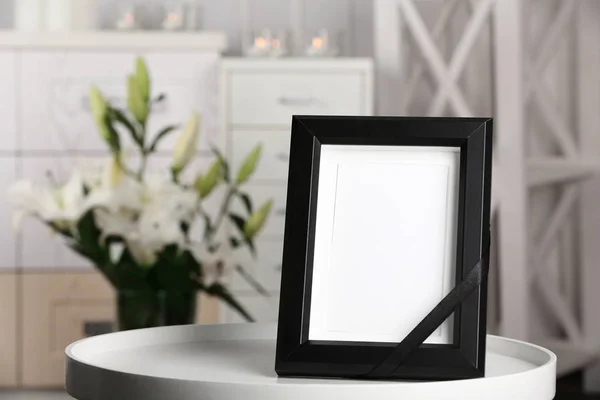室内のテーブルの上の黒いリボン付き葬儀フォト フレーム — ストック写真
