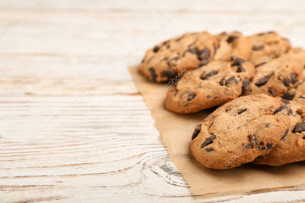Tasty cookies with chocolate chips on wooden background, closeup