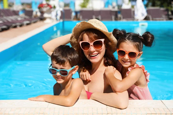 Happy family in swimming pool at resort