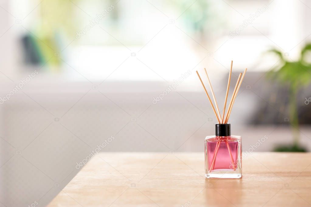 Aromatic reed air freshener on table indoors