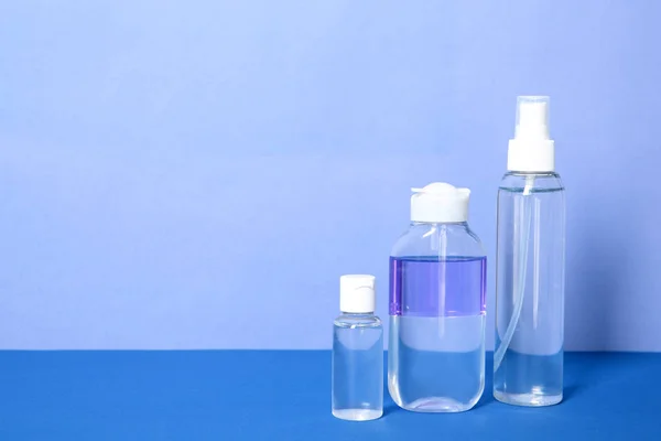 Diverse Bottiglie Cosmetiche Sul Tavolo Contro Sfondo Colore — Foto Stock