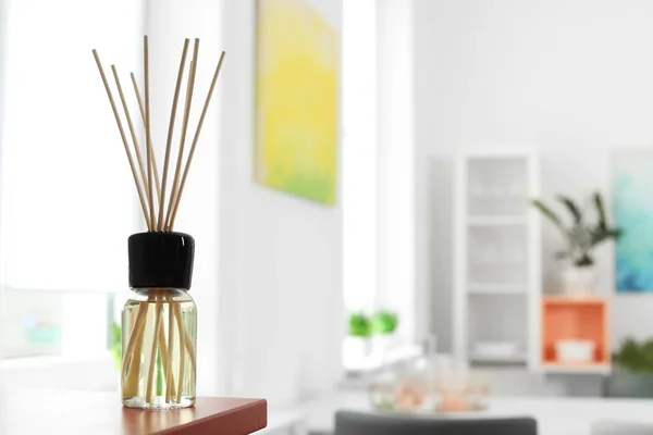 Aromatic reed air freshener on table in room