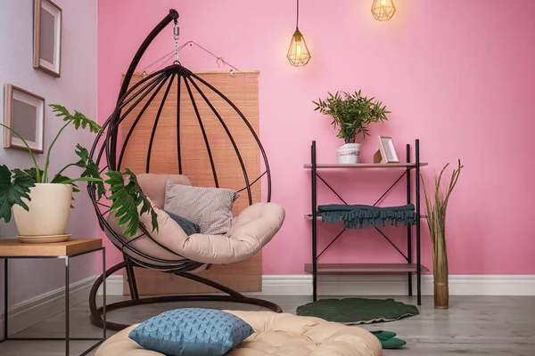 Cozy apartment with hanging chair near wall. Type of armchair for interior design Stock Image Everypixel