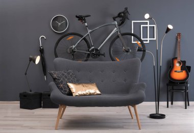 Stylish room interior with bicycle and sofa clipart
