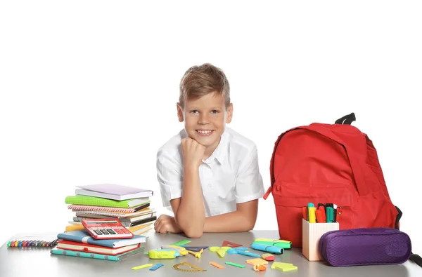 Söt Pojke Sitter Vid Bord Med Skolan Brevpapper Mot Vit — Stockfoto