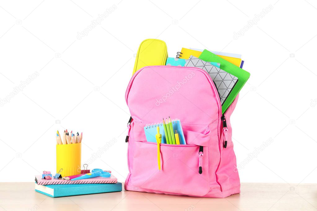 Color backpack with stationery on white background. Ready for school