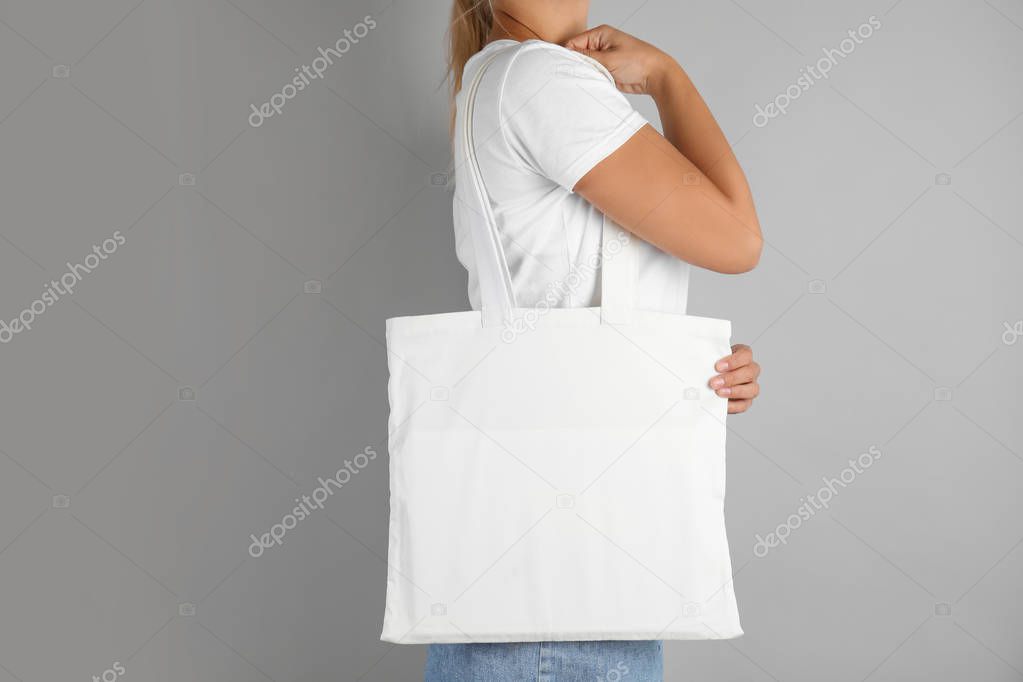 Woman with tote bag on grey background. Mock up for design