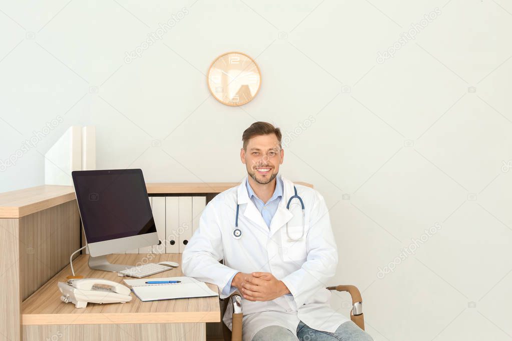 Male medical assistant at workplace in clinic. Health care service