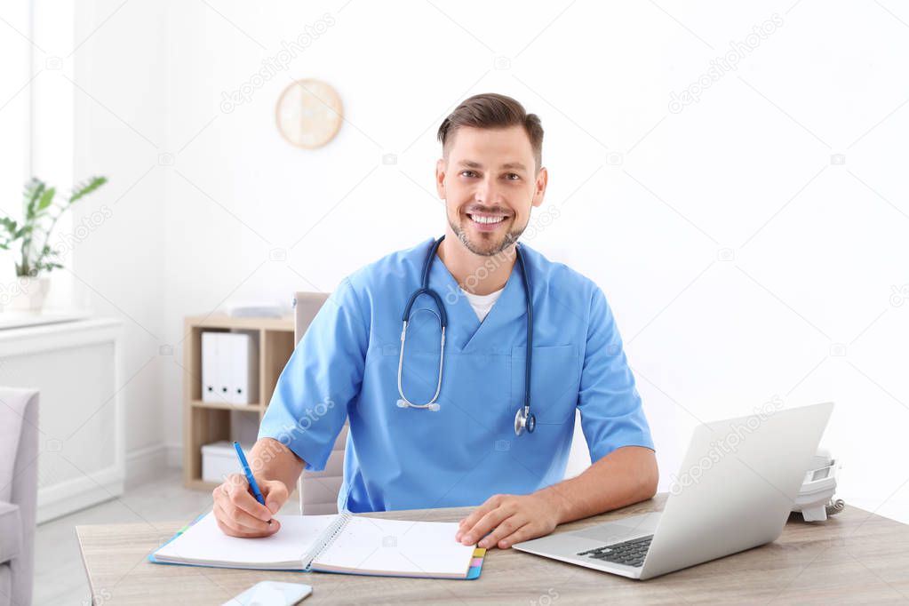 Male medical assistant at workplace in clinic. Health care service