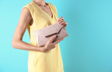 Genç kadın portre renk arka plan üzerinde çantalı şık kıyafeti