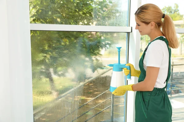 Female Janitor Cleaning Window Detergent Indoors — Stock Photo, Image