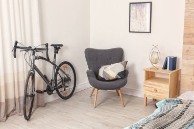 Modern apartment interior with bicycle near window clipart