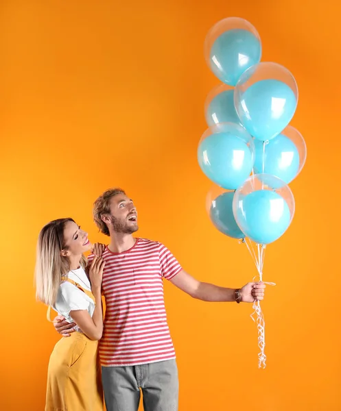 年轻夫妇与空气气球和空间为文本在颜色背景 — 图库照片
