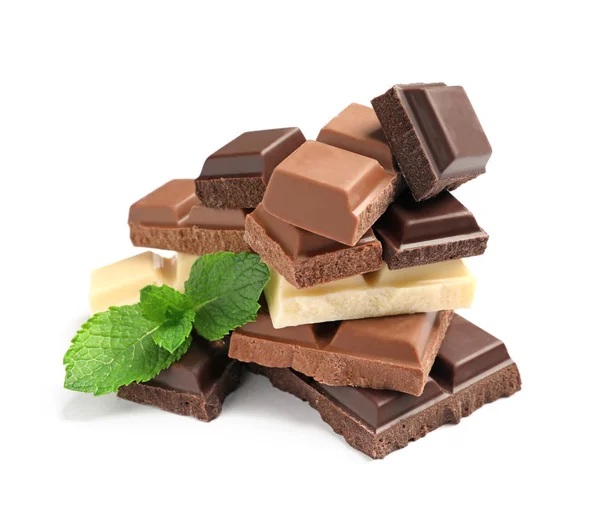 Different kinds of chocolate with mint on white background