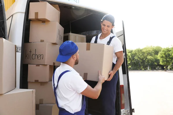 Male Movers Unloading Boxes Van Outdoors — Stock Photo, Image
