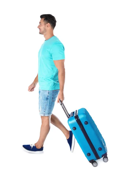 Junger Mann Geht Mit Koffer Auf Weißem Hintergrund — Stockfoto