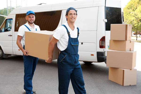 Male Movers Unloading Boxes Van Outdoors — Stock Photo, Image