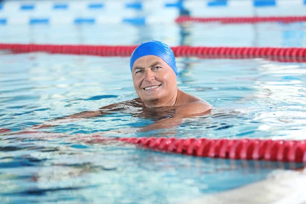 Sportive senior man in indoor swimming pool