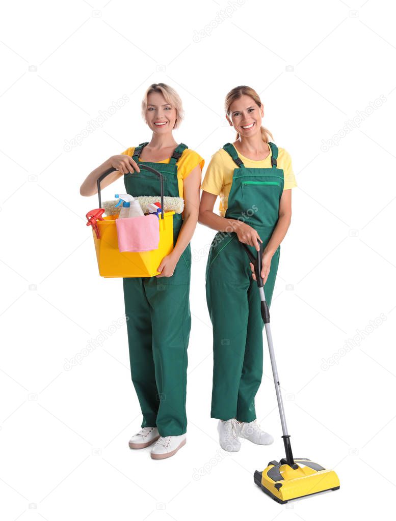 Female janitors with cleaning equipment on white background