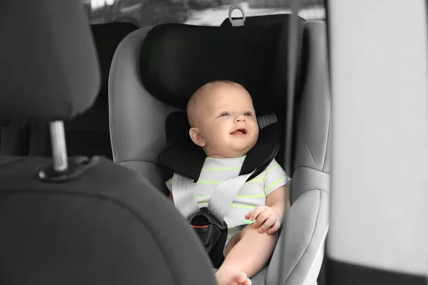 Little baby in child safety seat inside of car