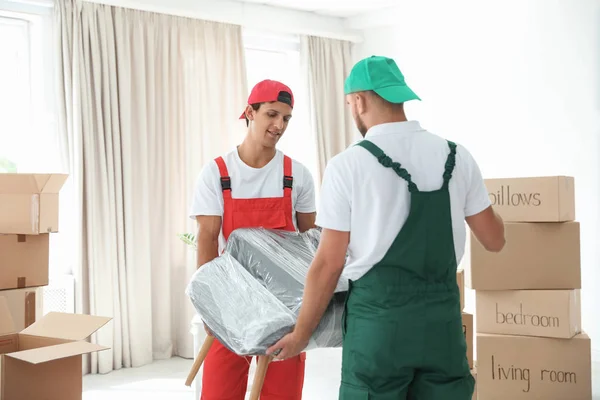 Male Movers Carrying Armchair New House — Stock Photo, Image