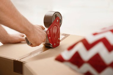 Adam closeup kapalı, karton kutu ambalaj. Taşınma günü