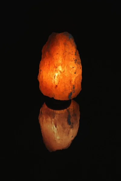 Himalayan salt lamp on black background