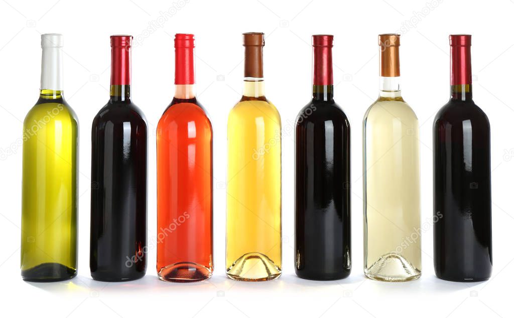 Bottles with different wine on white background
