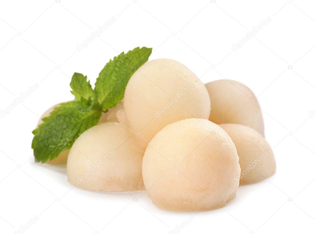 Melon balls and mint on white background
