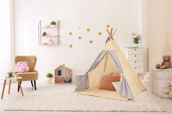 Cozy kids room interior with play tent and toys