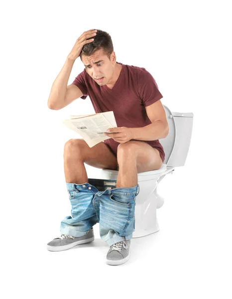 Young Man Reading Newspaper While Sitting Toilet Bowl Home — Stock Photo, Image