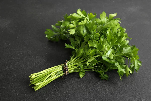 Bunch of fresh green parsley on black background