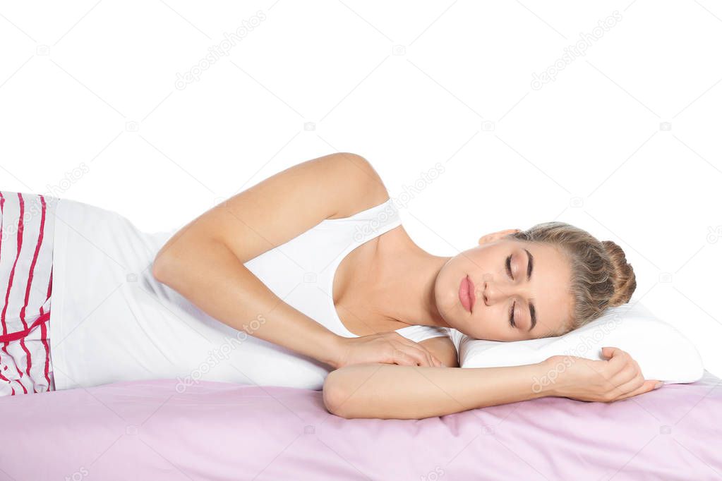 Young woman hugging pillow on bed at home