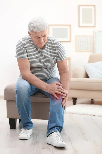 年配の男性が自宅で膝の痛みに苦しんで — ストック写真