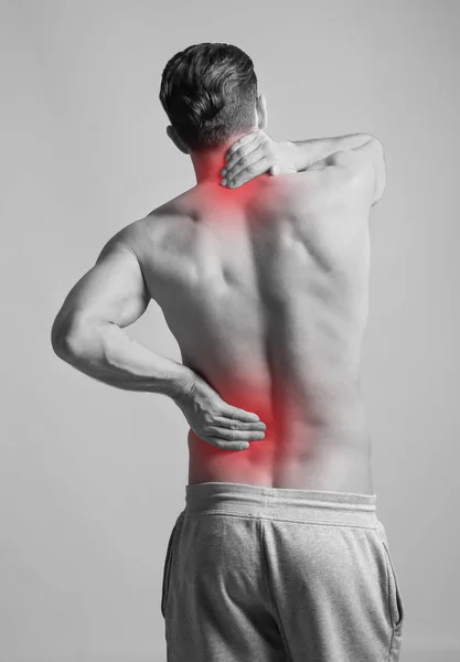 Man Suffering Back Pain Grey Background Black White Effect — Stock Photo, Image