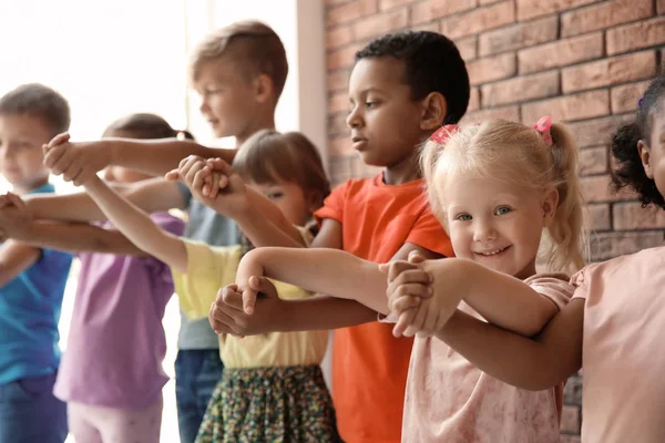 Little Children Raising Hands Together Indoors Unity Concept — 스톡 사진