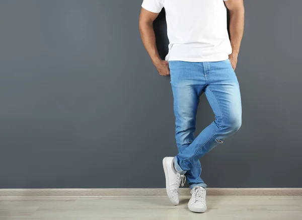 Young Man Stylish Jeans Grey Wall Space Text Focus Legs — Stock Photo, Image