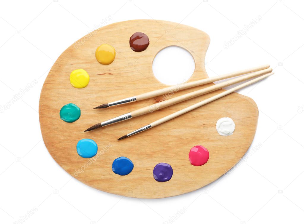 Palette with paints and brushes on white background, top view