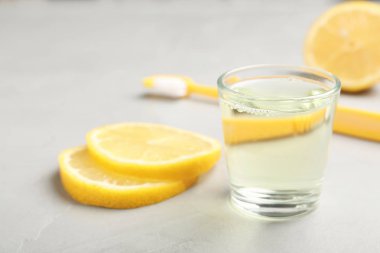 Cam gargara ve ışık arka plan üzerinde limon ile. Diş Bakımı