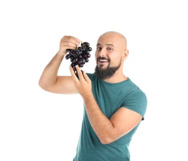 Overweight man with grapes on white background clipart