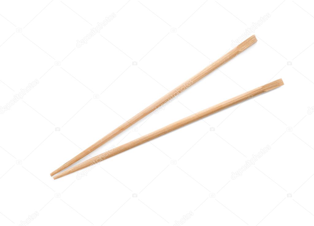 Chopsticks made of bamboo on white background, top view