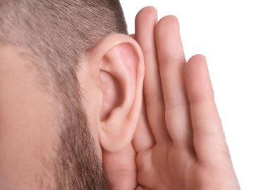 Young man with hearing problem on white background, closeup clipart