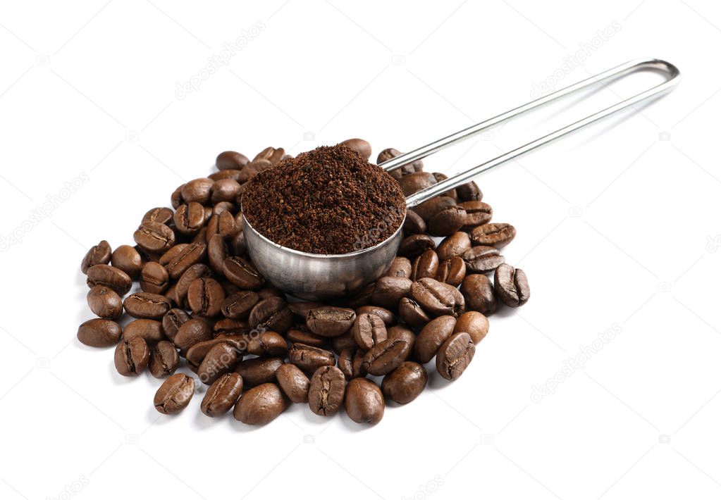 Scoop with coffee grounds and roasted beans on white background