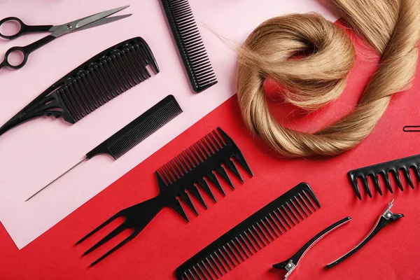 Flat lay composition with hair salon tools on color background