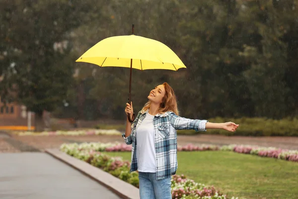 雨の下で明るい傘を持つ幸せな若い女性屋外 — ストック写真