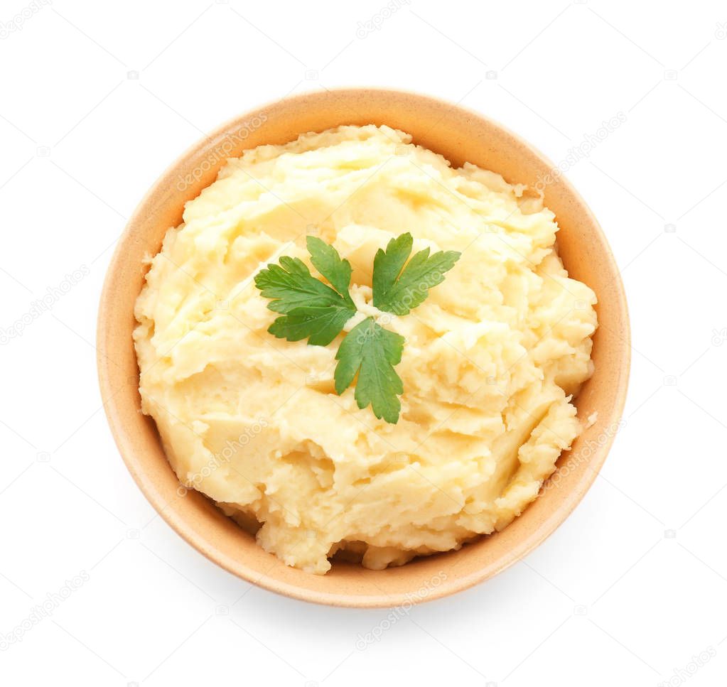 Bowl with tasty mashed potatoes on white background, top view