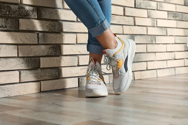 Woman Stylish Sneakers Brick Wall Indoors Closeup — Stock Photo, Image