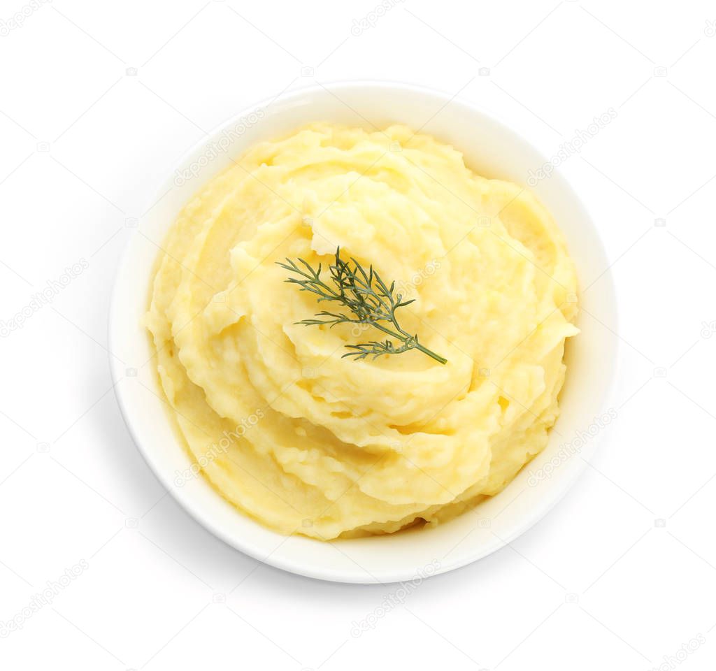Bowl with mashed potatoes on white background, top view