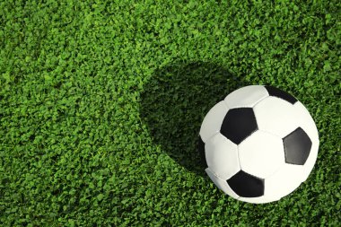 Yeşil futbol sahası çimlerinde futbol topu, üst manzara. Metin için boşluk