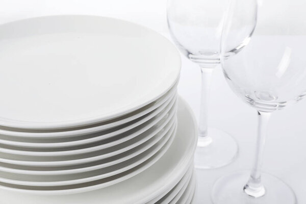 Set of clean tableware on white background, closeup. Washing dishes